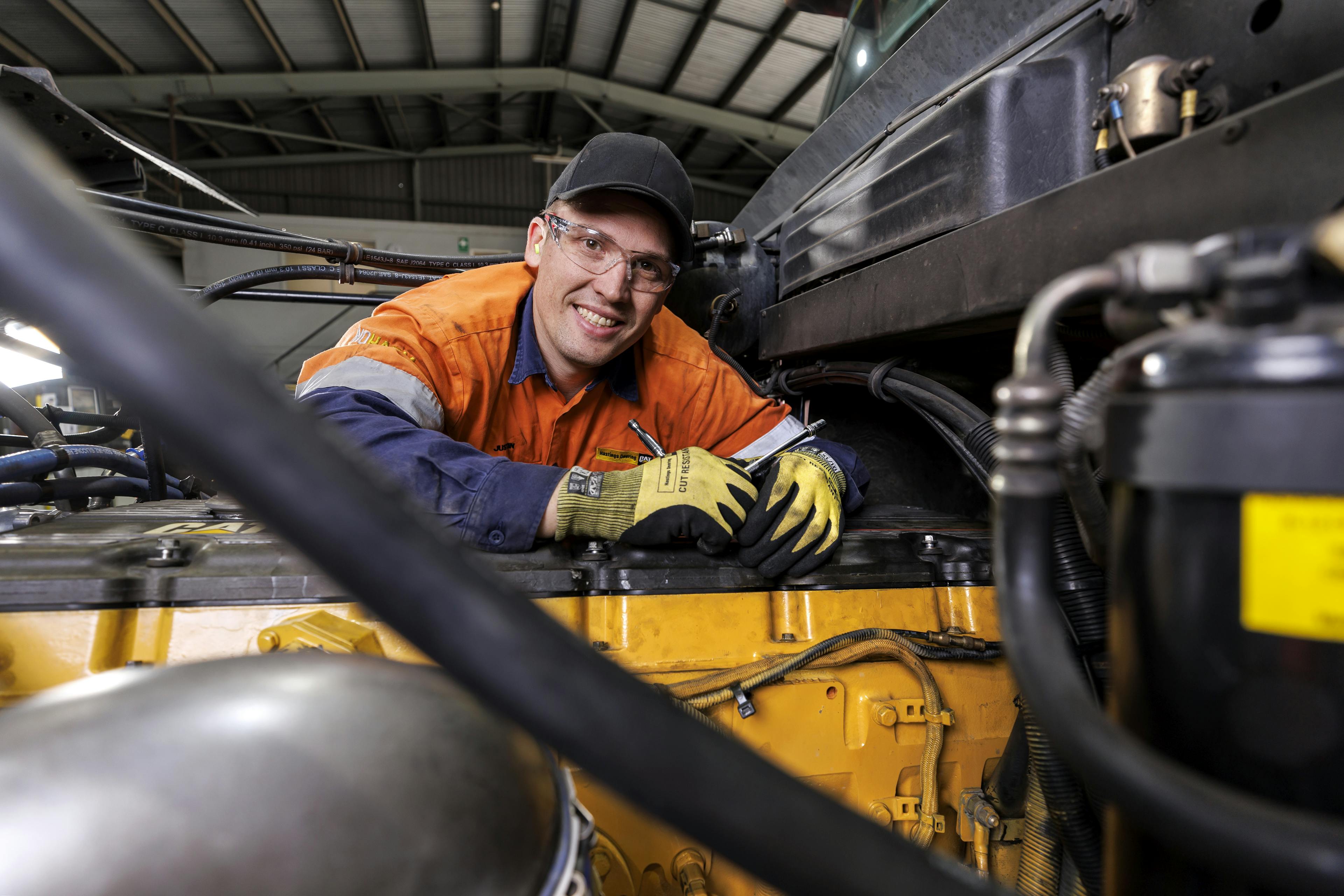 Hastings Deering - Operations Recruitment Campaign technician working on engine